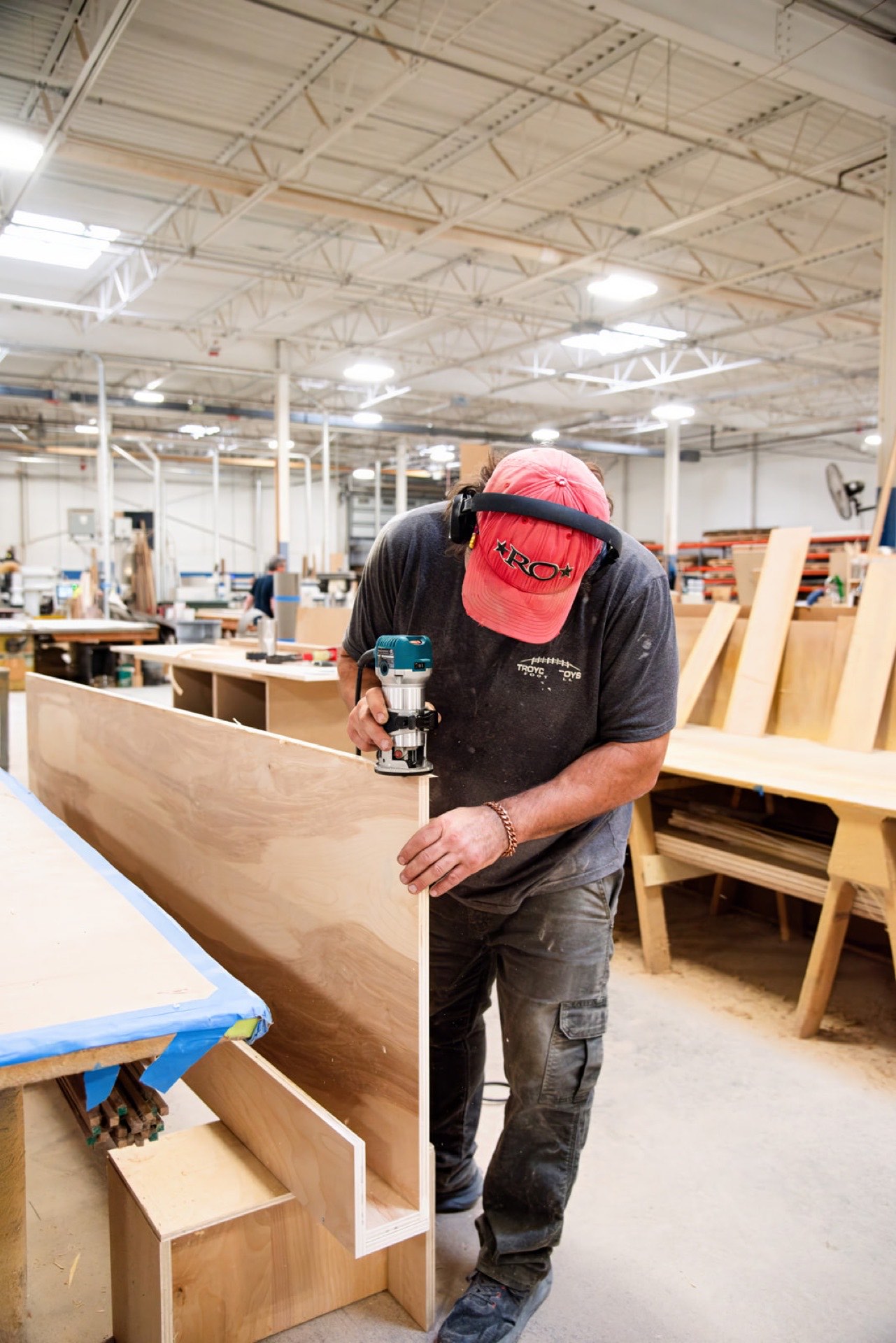 Carpenter routing the edge of a casework panel
