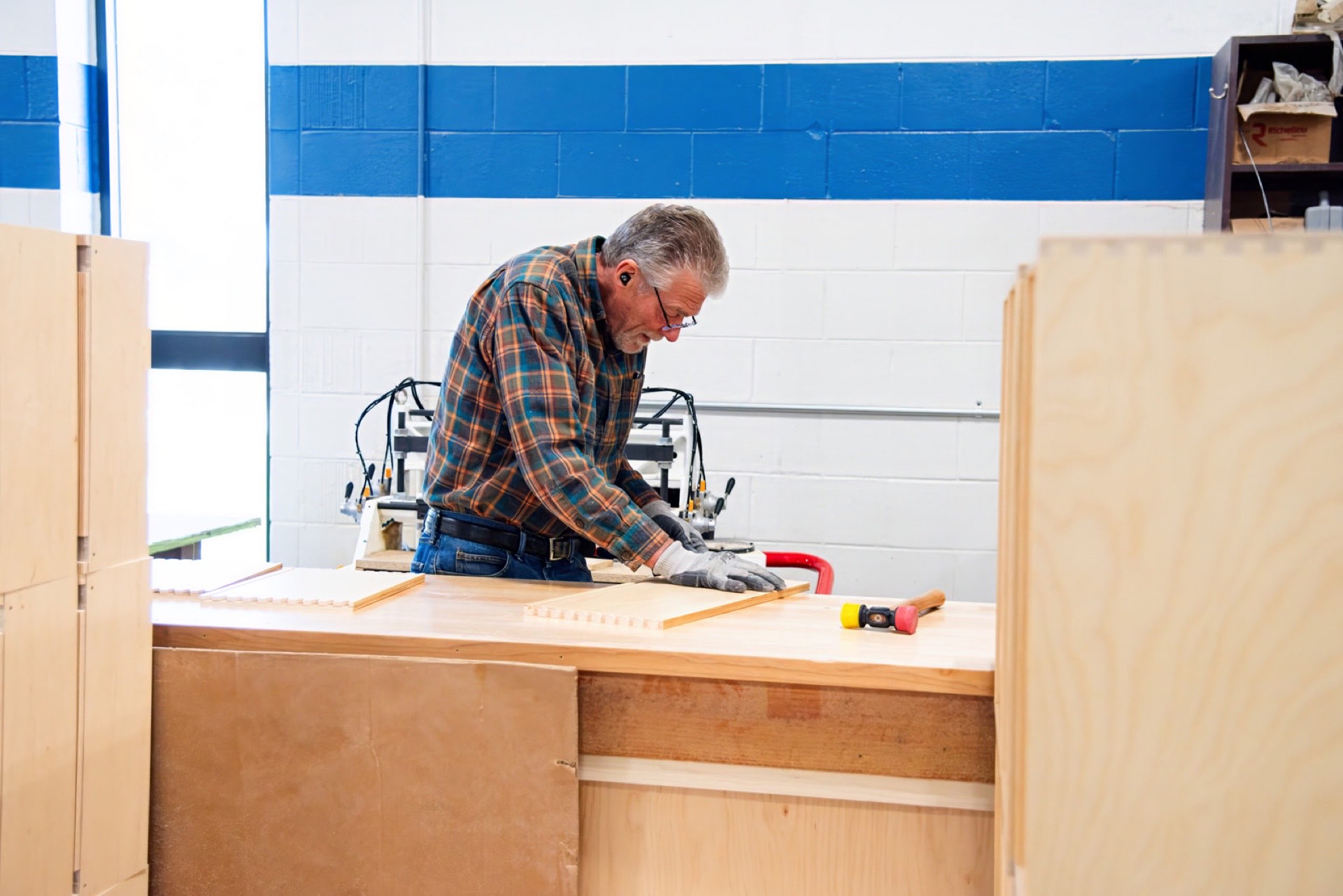 Veteran Sterling carpenter dry-fitting a drawer at the bench