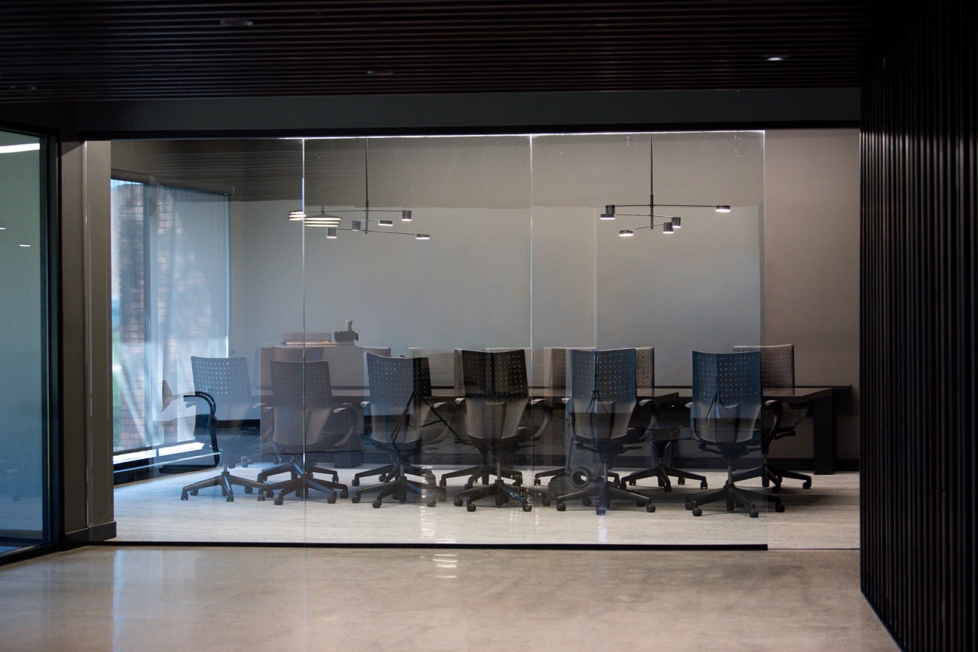 Finished installation in a corporate boardroom — conference table and millwork ready for occupancy