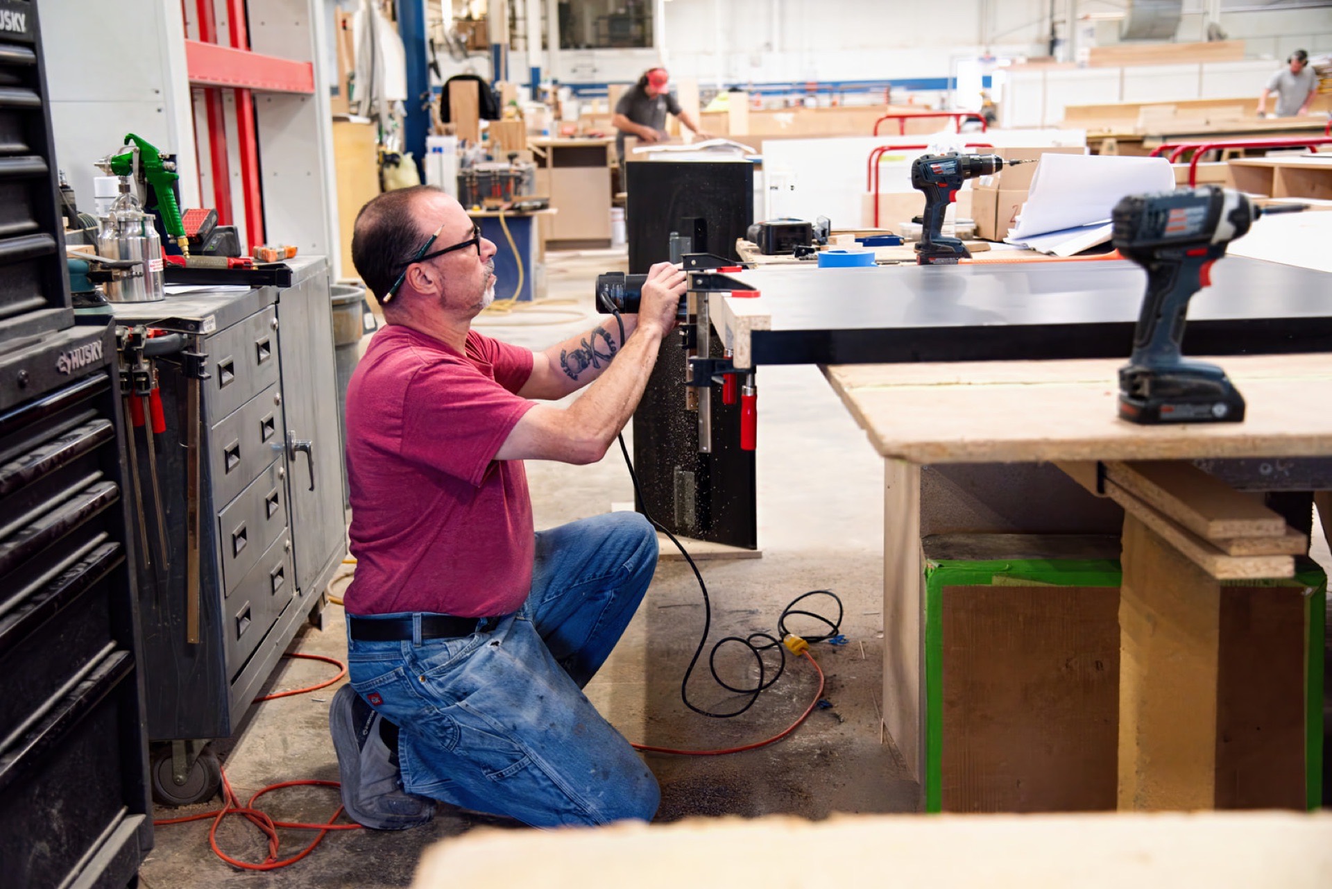 Sterling Millwork craftsman assembling a cabinet on the shop floor