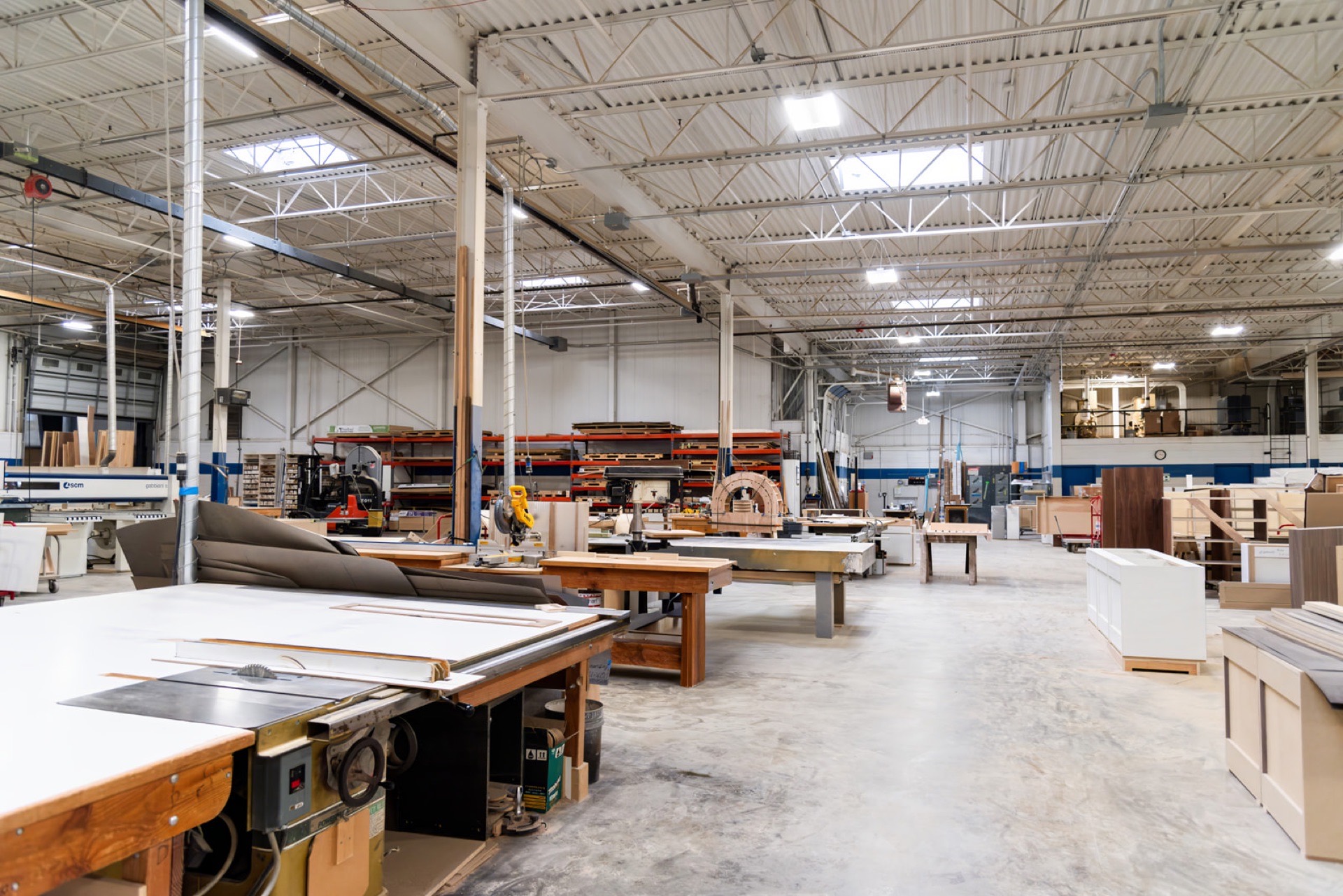 Wide view of Sterling Millwork shop floor with assembly stations under work lights