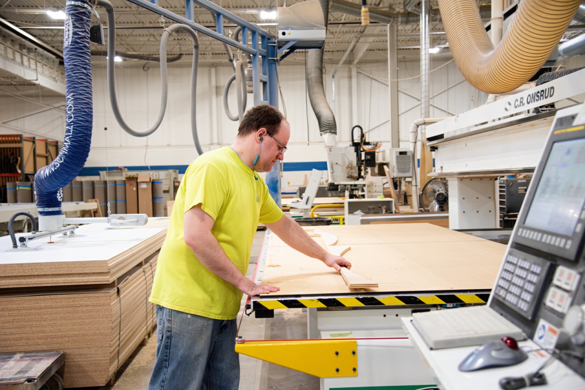 Operator at the C.R. Onsrud CNC router cutting panel parts